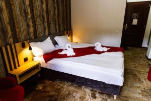 a hotel room with a bed with towels on it at Hotel Relax & Resort Sovata in Sovata