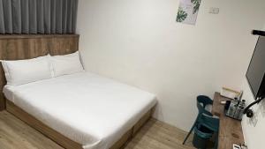 Voodi või voodid majutusasutuse Benz 賓士溫泉旅館 toas