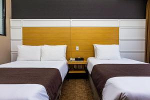 Postel nebo postele na pokoji v ubytování Eastern Hotel Jeju