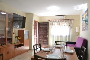 a dining room with a table and chairs and a kitchen at Camins 2 in Riumar