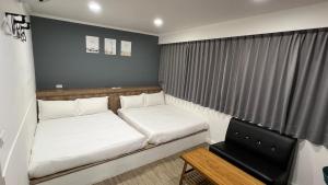 Voodi või voodid majutusasutuse Benz 賓士溫泉旅館 toas