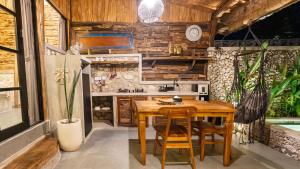 a wooden kitchen with a wooden table and chairs at Alma Surf Villas 2 - Cozy 01 Bed with Private Pool in Uluwatu