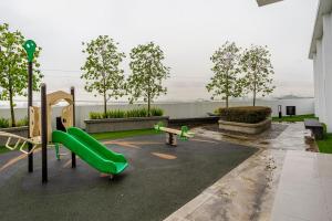 a playground with a green slide in a building at Subang Jaya Armani Soho in Subang Jaya
