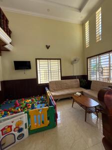 a living room with a couch and a play area at AHHA Boutique Kampot in Kampot