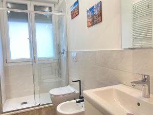 a bathroom with a shower and a toilet and a sink at Suite Emilia 4 in Bologna