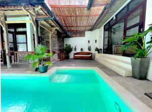 a swimming pool in the backyard of a house at Villa Bambu Private Pool in Uluwatu