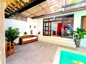 an outdoor patio with a bench and a table at Villa Bambu Private Pool in Uluwatu