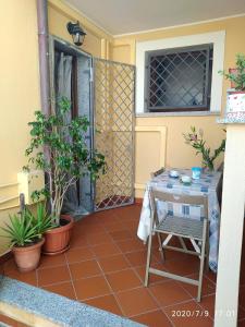 a patio with a table and a chair in front of a door at Alice e il mare in Alghero