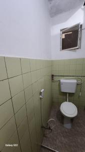 a bathroom with a toilet and a window at Mardai Homestay in Arusha +15 photos