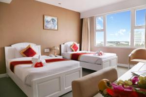 Postel nebo postele na pokoji v ubytování NINH KIỀU FORTUNELAND HoTel