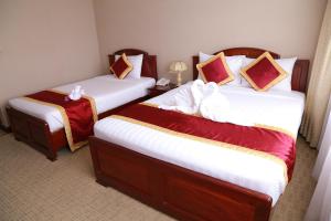 Postel nebo postele na pokoji v ubytování NINH KIỀU FORTUNELAND HoTel