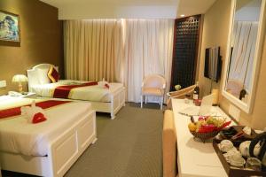 Postel nebo postele na pokoji v ubytování NINH KIỀU FORTUNELAND HoTel