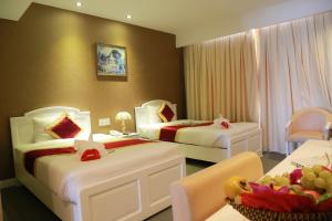 Postel nebo postele na pokoji v ubytování NINH KIỀU FORTUNELAND HoTel