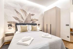 a bedroom with a large bed with two towels on it at ZAGABRIA - Modern Boutique Studios by Main Square in Zagreb