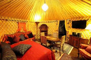 een kamer met een bed en een tafel in een yurt bij JURTE - Traumhafter Meerblick, beheizter Pool, Sauna, Billiard, Tischtennis, Garten in La Asomada