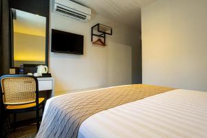 Postel nebo postele na pokoji v ubytování De Quinton Hotel