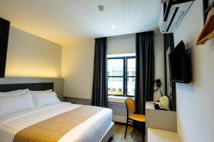 Postel nebo postele na pokoji v ubytování De Quinton Hotel