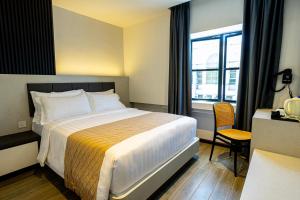 Postel nebo postele na pokoji v ubytování De Quinton Hotel