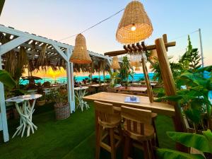 a restaurant with tables and chairs and lights at Hotel Parthenon Rodos city in Rhodes Town