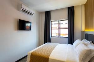 Postel nebo postele na pokoji v ubytování De Quinton Hotel