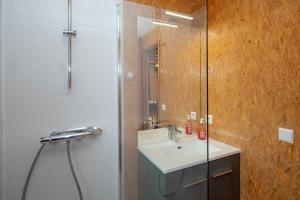 a bathroom with a sink and a shower at Chalet 331 - Village nordique in La Féclaz +15 photos