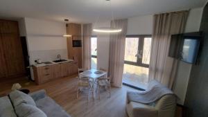 a living room with a couch and a table at Horizon Park Boszkowo in Boszkowo-Letnisko +3 photos