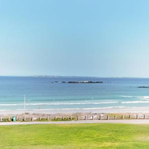 a beach with the ocean in the background at Private condo in secure area in Cape Town