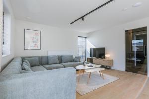 a living room with a couch and a table at Maison Sebastian in Nieuwpoort