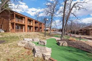 a golf course with rocks in front of a building at Still Waters Resort in Branson