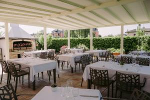 a group of tables and chairs under a pavilion at Locanda Al Ponte de Fero in Jesolo