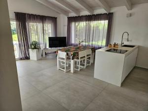 a kitchen with a sink and a table in a room at White House in Civitanova Marche