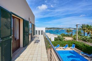 a balcony with a view of the water at Villa Mesquida in Portocolom
