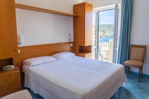 Posteľ alebo postele v izbe v ubytovaní Hotel Bellavista