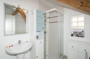 a white bathroom with a sink and a shower at maison proche du marche - 8798 in Soulac-sur-Mer +7 photos
