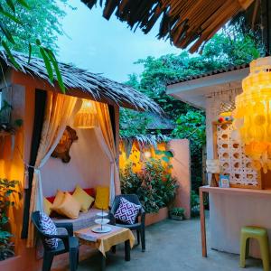 a patio with a couch and chairs and a table at RP Botanical Park, Hotel & Resort in Tagbina