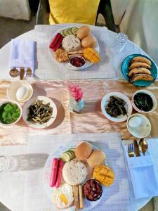 a table with plates of food on top at RP Botanical Park, Hotel & Resort in Tagbina