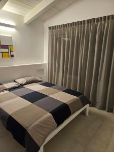 a bedroom with a bed and a curtain at White House in Civitanova Marche