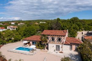 an aerial view of a house with a swimming pool at Villa Oliveti in Malinska