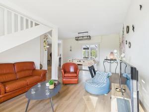 a living room with a couch and a table at Jolie maison avec jardin à 450m de la plage pour 8 in Batz-sur-Mer