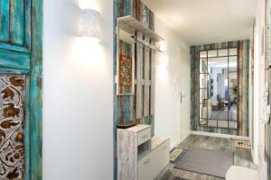 a room with a hallway with a mirror at Alte Fischfabrik Am Leuchtturm in Lauterbach +19 photos