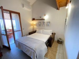 a small bedroom with a bed and a window at Costa Rei Panoramic Terrace- Free Parking- BBQ-Netflix in Costa Rei