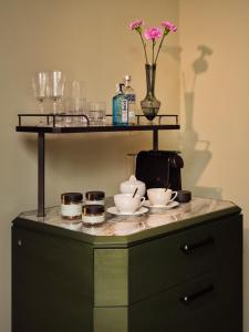 a shelf with plates and bowls on top of a cabinet at Sir Prague, part of Sircle Collection in Prague