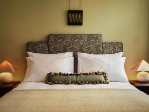 a bedroom with a bed with a headboard and pillows at Sir Prague, part of Sircle Collection in Prague
