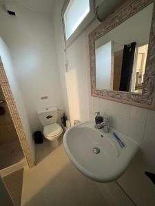 a bathroom with a sink and a toilet and a mirror at Bentley studio in Sanary-sur-Mer