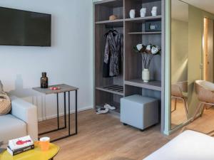 a living room with a couch and a table at ibis Styles Beaulieu sur Mer in Beaulieu-sur-Mer
