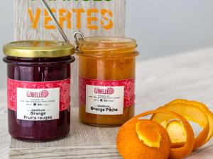 two jars of preserves next to a sliced orange at ibis Styles Beaulieu sur Mer in Beaulieu-sur-Mer