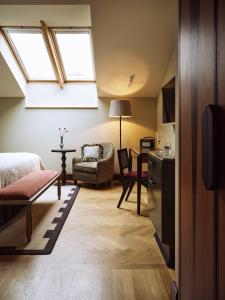 a room with a bed a chair and a window at Sir Prague, part of Sircle Collection in Prague
