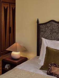 a bedroom with a bed with a lamp on a table at Sir Prague, part of Sircle Collection in Prague