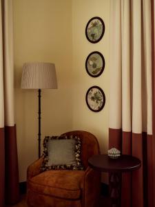 a room with a chair and a lamp and a table at Sir Prague, part of Sircle Collection in Prague