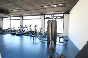 a gym with a row of treadmills and machines at Villa Almendro Santa Rosalia Lake and Life Resort by PREMIUM SPAIN PROPERTIES in Torre-Pacheco